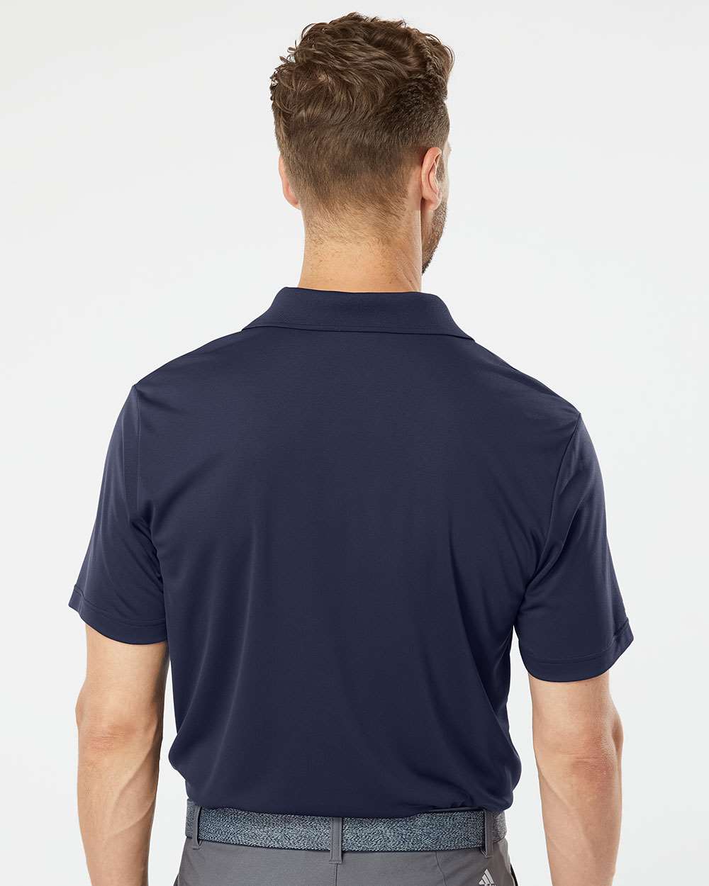 Navy performance polo on model, back — Big Sioux Swag team apparel